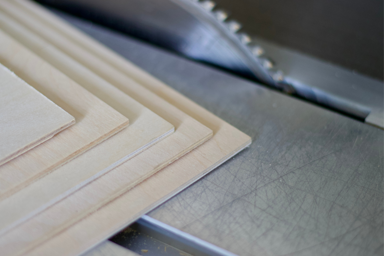 Plywood sheets being cut to size on a saw table